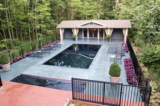 The automatic cover starting to run across the near end of the pool