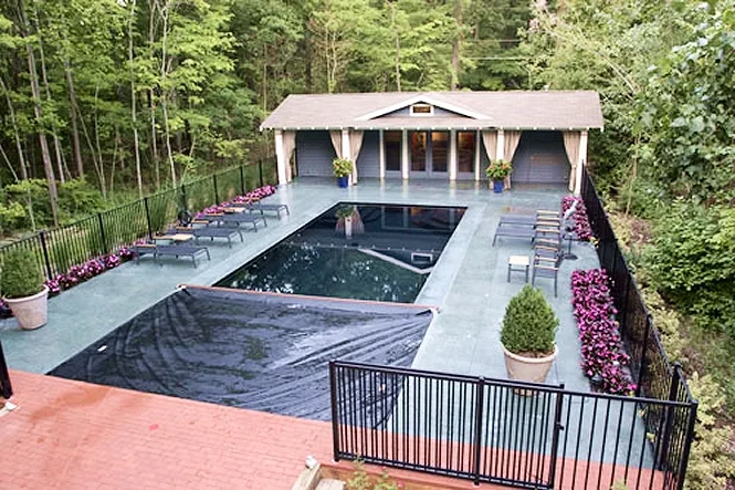 The automatic cover about halfway across the pool