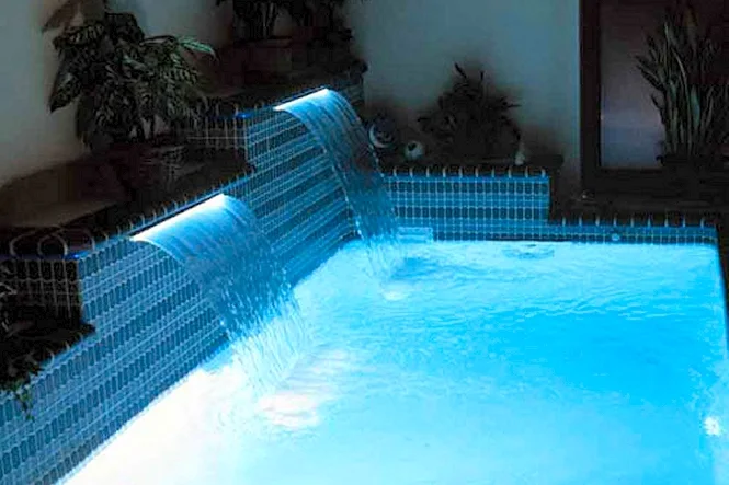 Sheer Descent waterfalls lit blue by fiber optic lighting