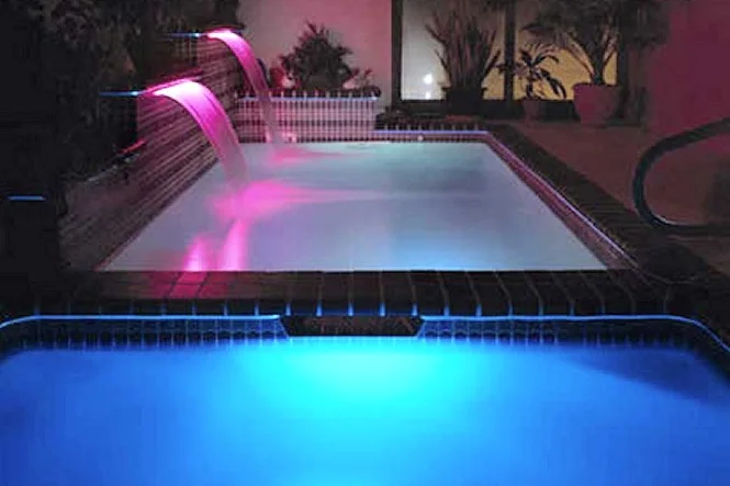 Pool and spa glowing pink and blue as the lighting colors change