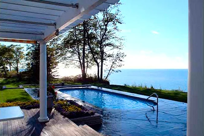 The pool and the lake seen from under the porch pergola
