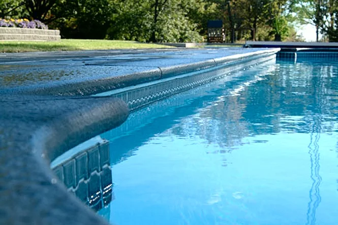 Low view across the water to the tile line and coping