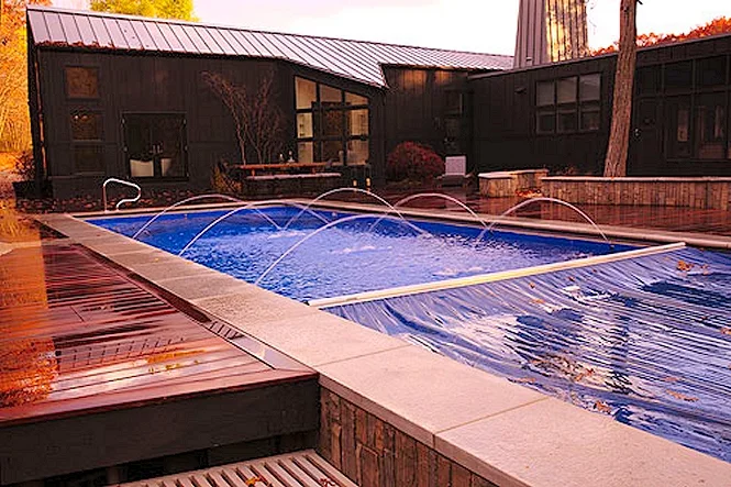 Deck jets along the pool with the house behind