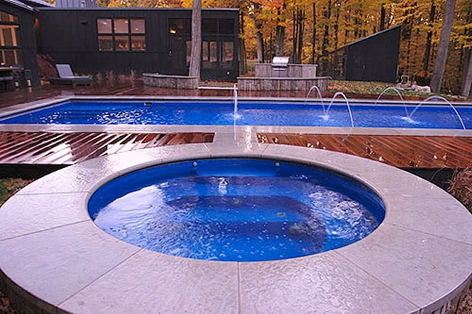 The round Sarasota spa in front, the long pool behind