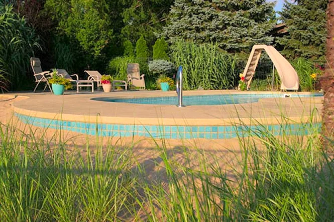 The pool seen from the sand beach, with tall grasses in front