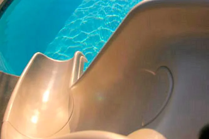Close view of a beige slide at the pool edge