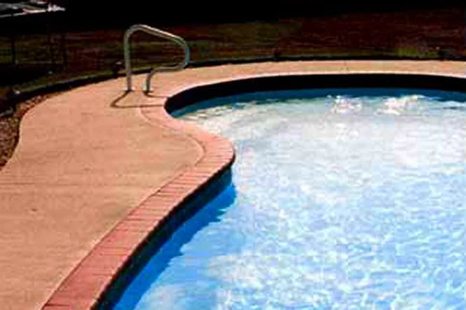 Blue water and brick coping on a sunny morning