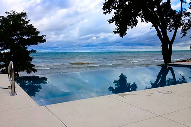 Water spilling over the vanishing edge with Lake Michigan behind