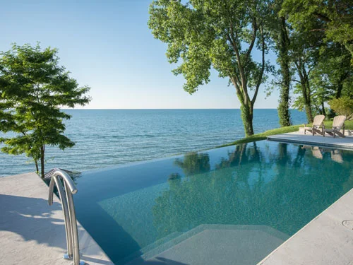 Pool ladder and the vanishing edge lined up with the lake horizon