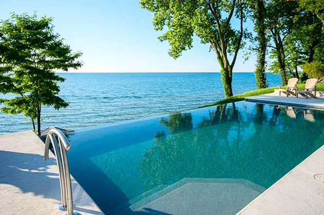 Blue water of the pool running out to the lake on a clear day