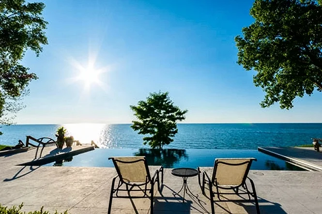 Lounge chairs on the deck facing the sun over the lake
