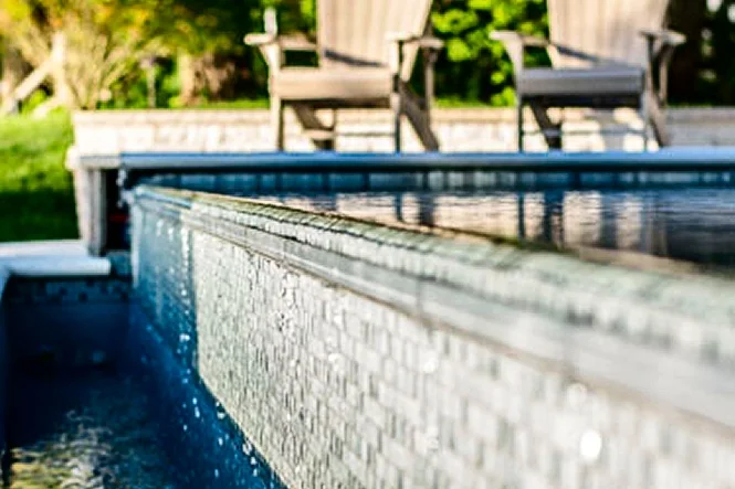 Close view of water sheeting over a tiled spillover wall
