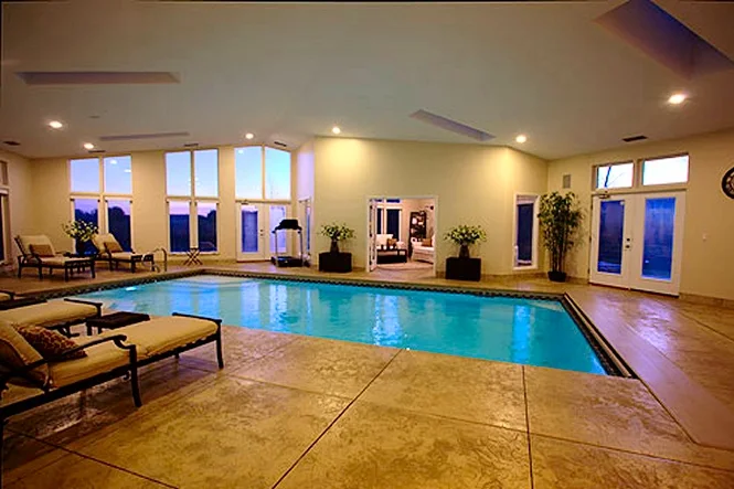 The indoor pool from the corner, with loungers along the windows