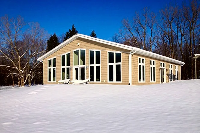 The natatorium from the side, with snow on the ground