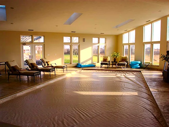 Afternoon sun across the pool room floor and loungers