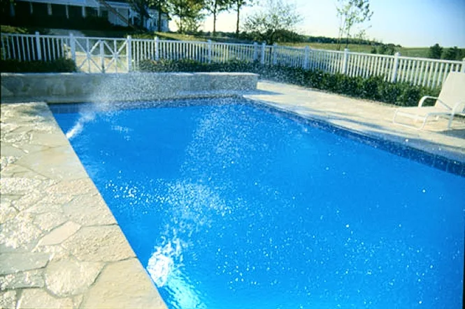 Spray fountains running across the blue pool