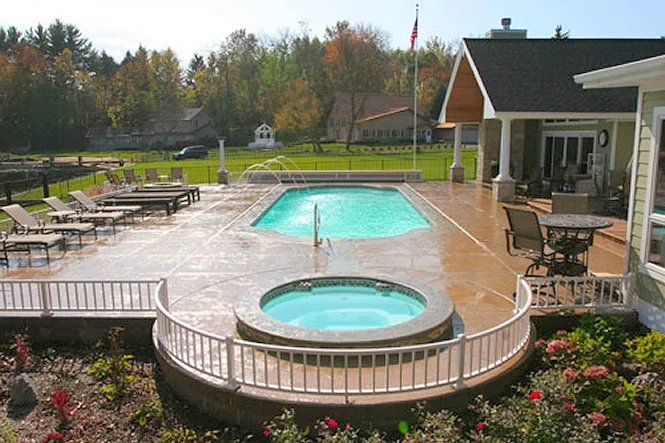 The Phoenix pool with its round island spa and white rail, the patio and house behind