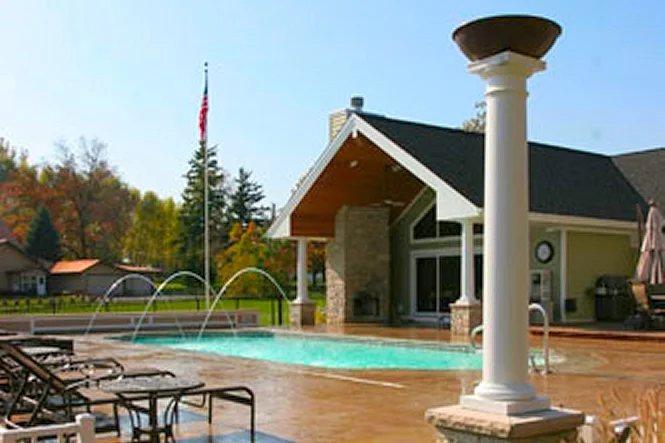 A white torch column, deck jets and the house on a sunny day