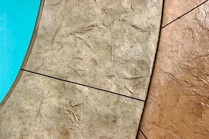 Close view of the stone-textured stamped concrete at the pool edge