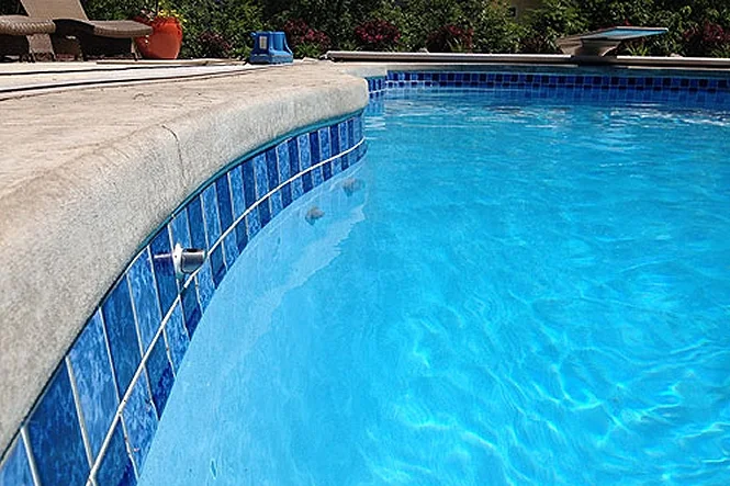 Close view of blue waterline tile along the curved edge