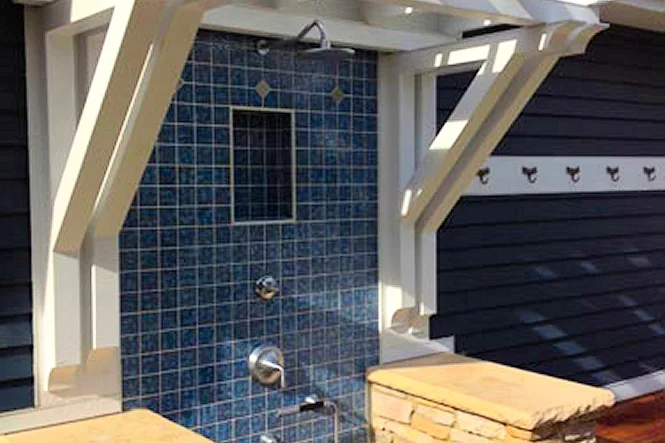 Blue tiled outdoor shower under the pergola